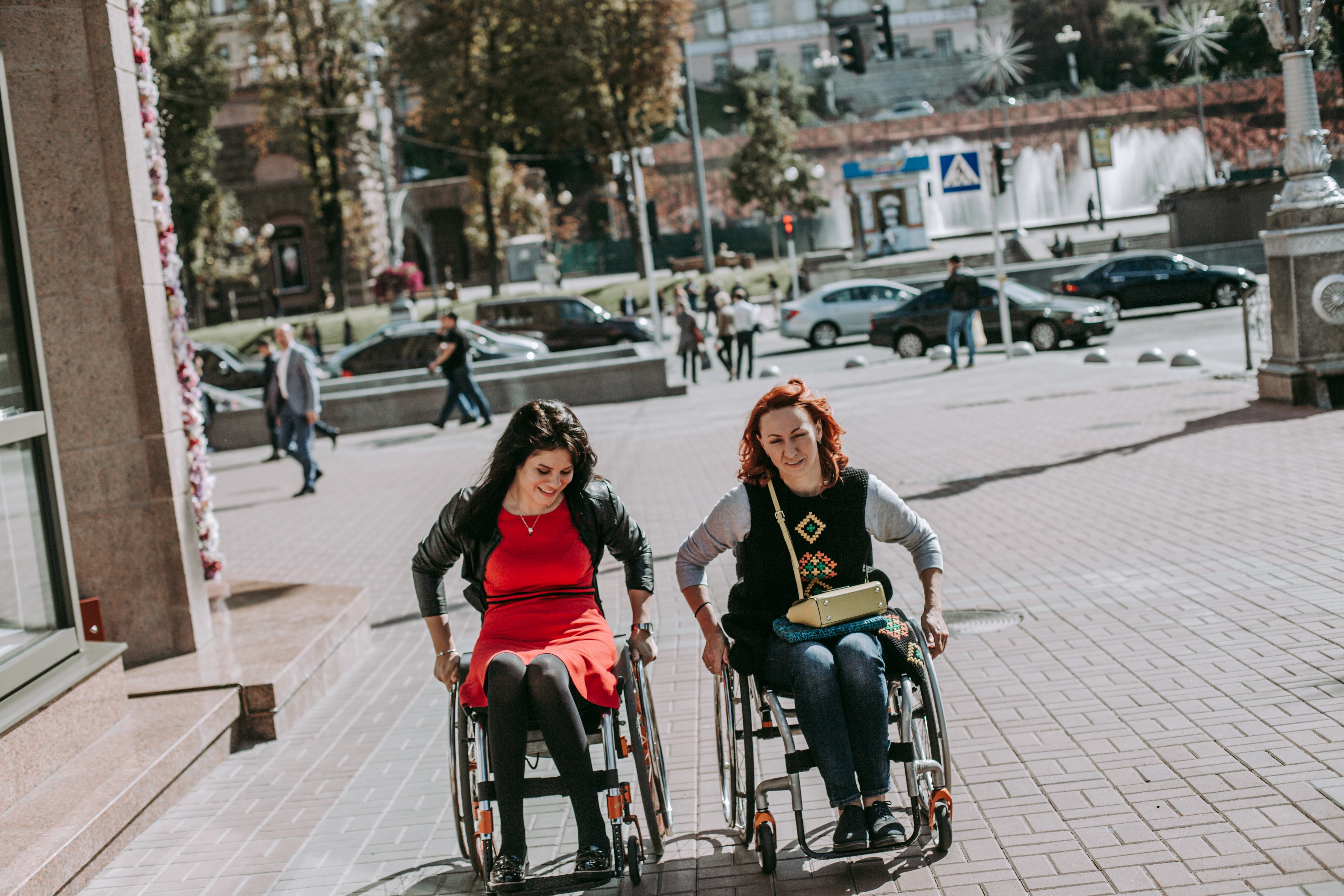 Two Girls In The City On Wheelchairs