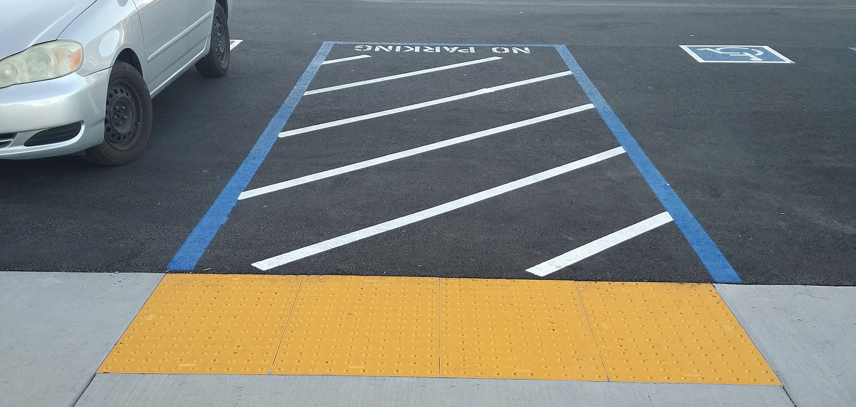 Detectable Warning Surface in a Parking Lot Next to a Handicap Parking Space